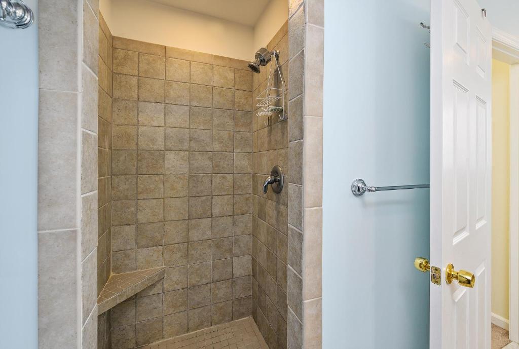 a bathroom with a shower with a glass door at The Sweets Spot in Greenbackville
