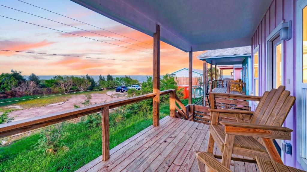 a porch with a chair and a view of a street at Laguna Sunset by AvantStay in Corpus Christi