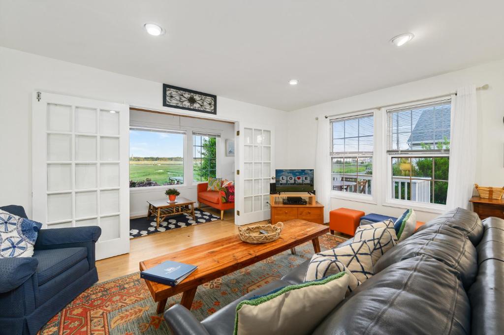 a living room with a couch and a table at To the Lighthouse in Birch Town