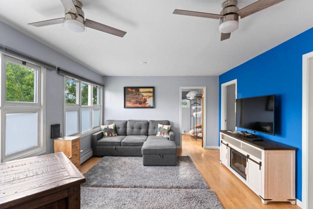 a living room with a couch and a tv at Close To Airport - Shared Space - Fast WI-FI in Anchorage
