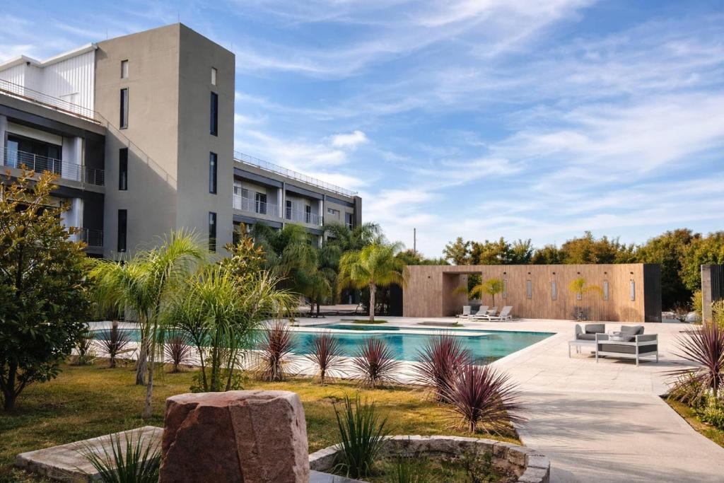 a courtyard with a swimming pool in front of a building at Radisson Red Funes in Rosario