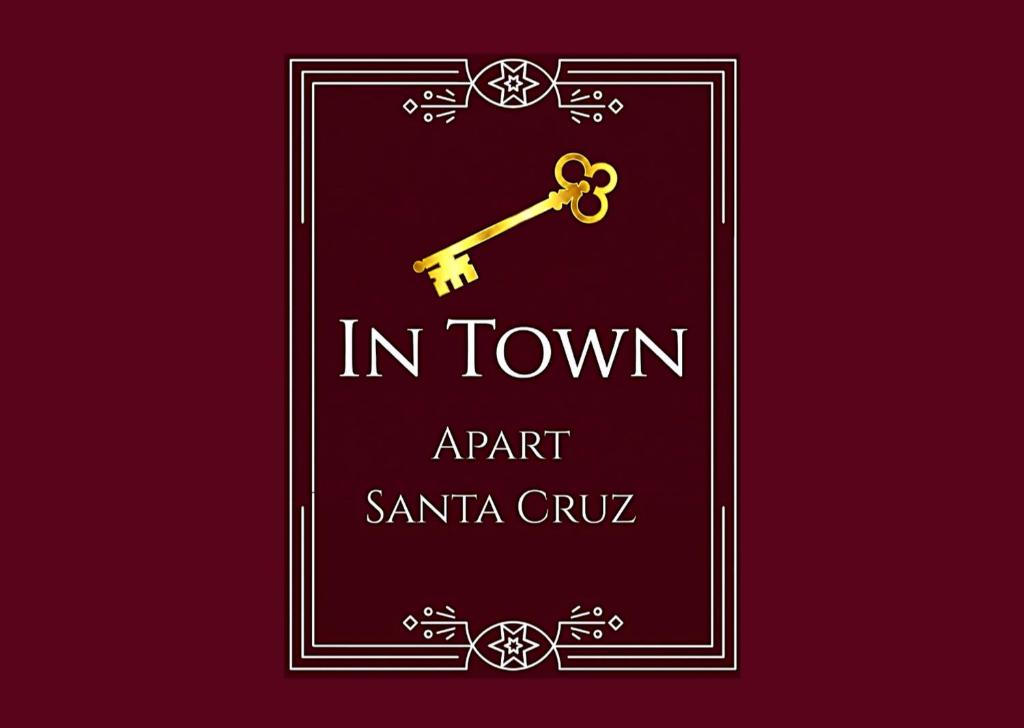a sign that reads in townagent santa cruz with a gold key at InTown Apart Santa Cruz in Santa Cruz