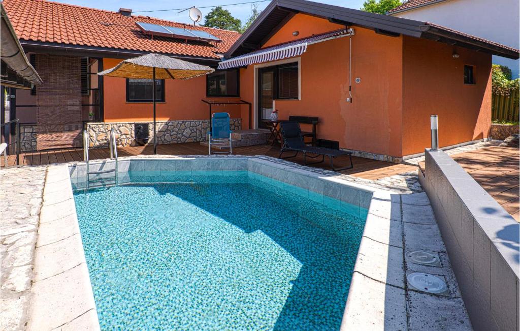 a swimming pool in front of a house at Awesome Home In Karlovac in Karlovac