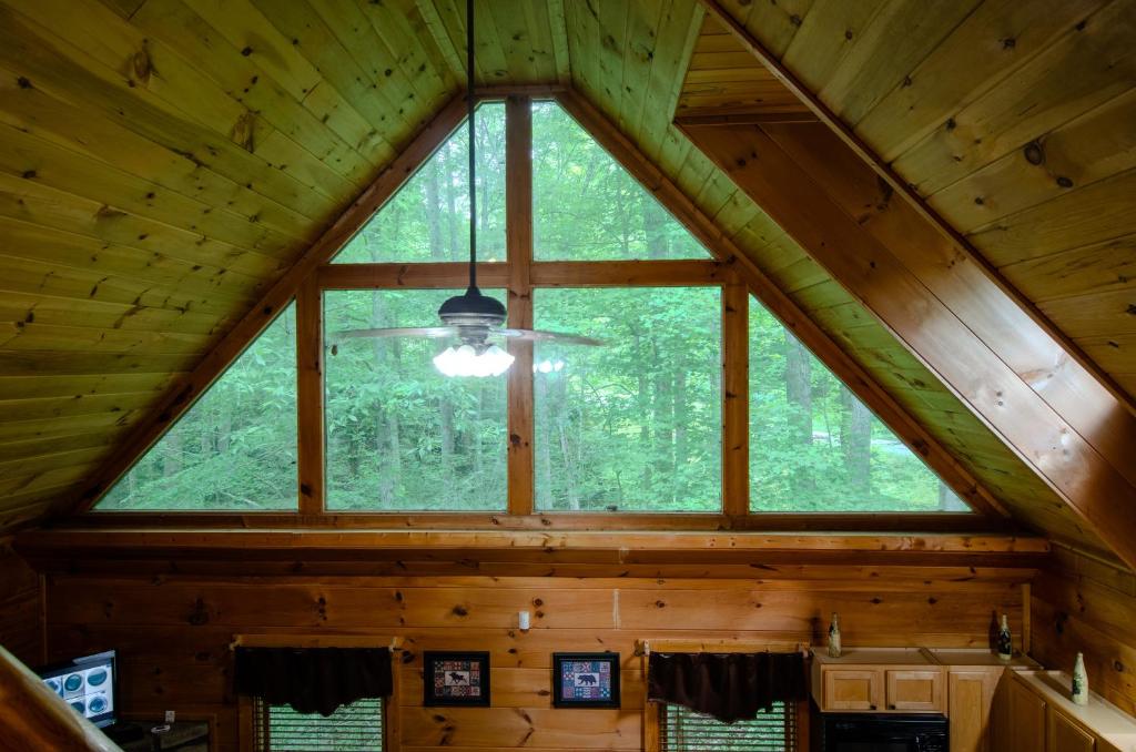 a large window in a cabin with a ceiling at Naughty Pines in Pigeon Forge