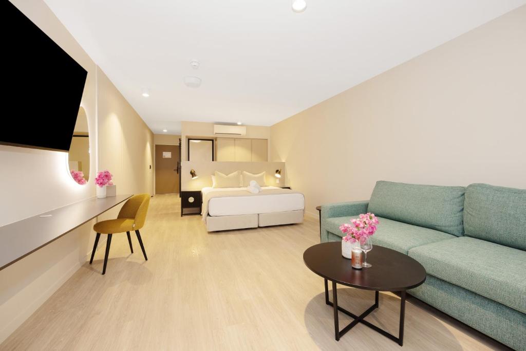 a living room with a couch and a bed at Picnic Bay Hotel in Picnic Bay