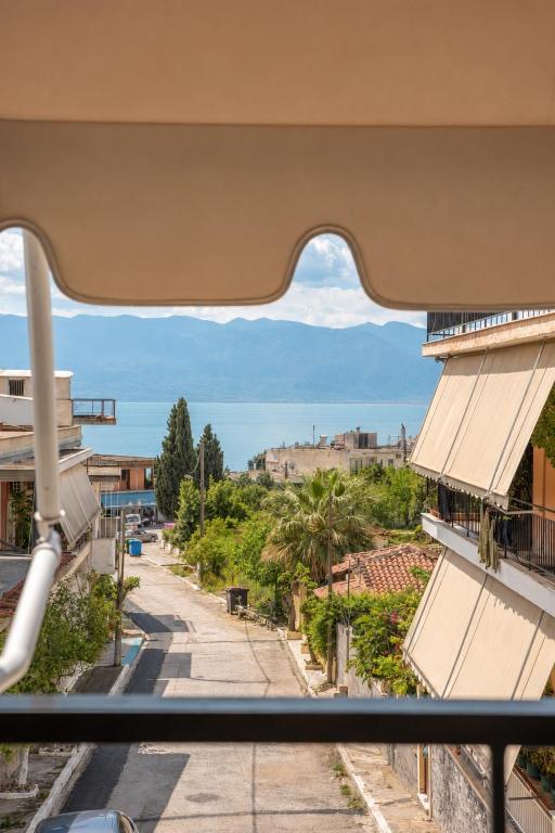 a view from a window of a street at Stylida Apartment - Ocean Air & Quiet Nights! in Stilís