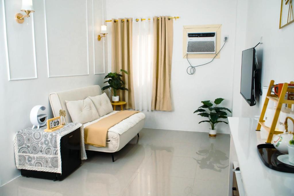 a living room with a couch and a tv at Casa Marelle in Lapu Lapu City