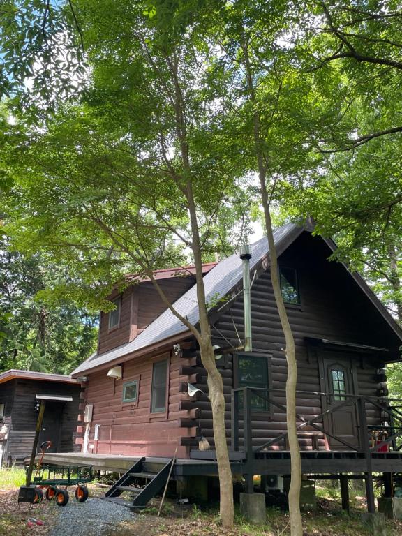a large wooden house with a gambrel roof at A Sleeping Forest in Ito