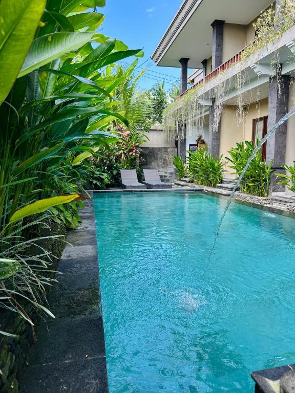 a swimming pool in the middle of a house at Pulu Sari Suite Ubud in Ubud