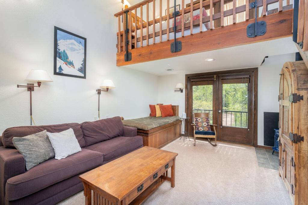 a living room with a couch and a table at Manitou Lodge 6 by Alpine Lodging Telluride in Telluride