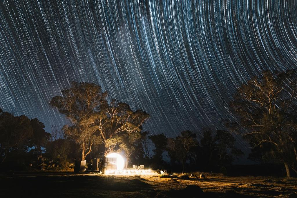 a group of star trails in the sky at night at Captain Thunderbolt Bubbletent at Mirumiru in Tenterfield