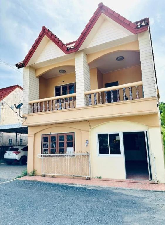 a house with a balcony on top of it at The Jetty in Nathon Bay