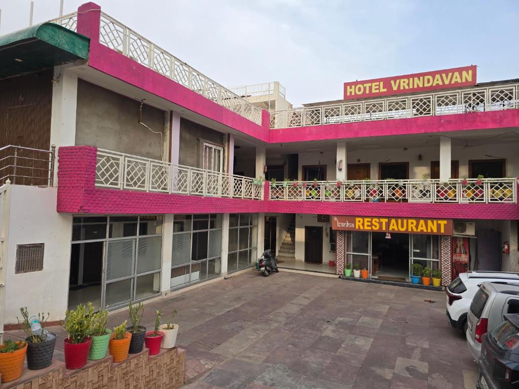 a hotel with a parking lot in front of it at Hotel Vrindavan in Fatehpur Sīkri