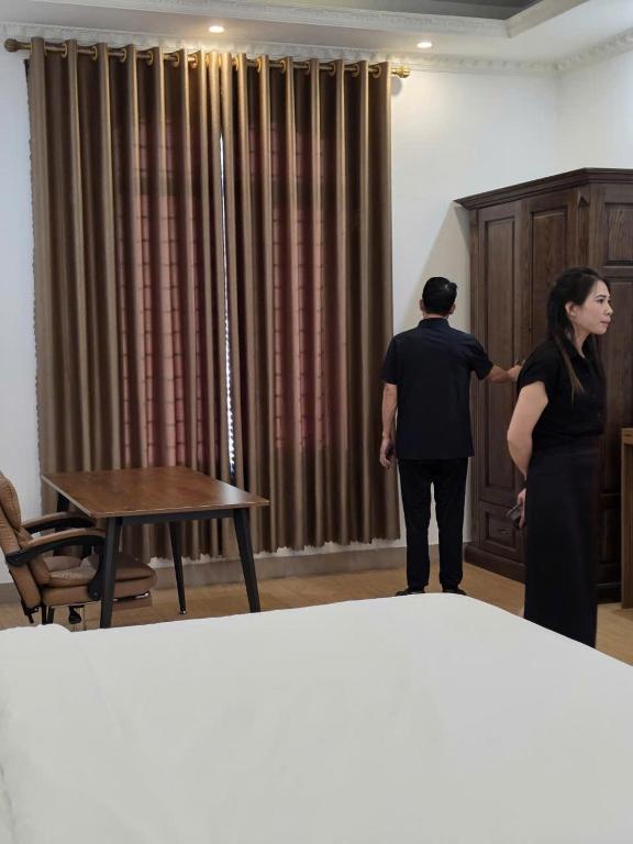 a man and a woman standing in a room at Khách Sạn VizGoo in Bắc Ninh