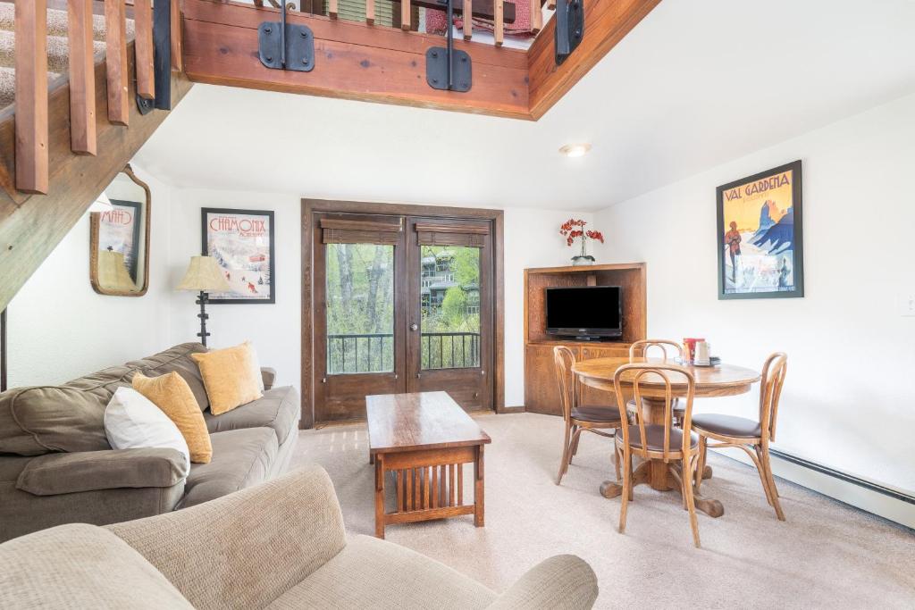 a living room with a couch and a table at Manitou Lodge 7 by Alpine Lodging Telluride in Telluride