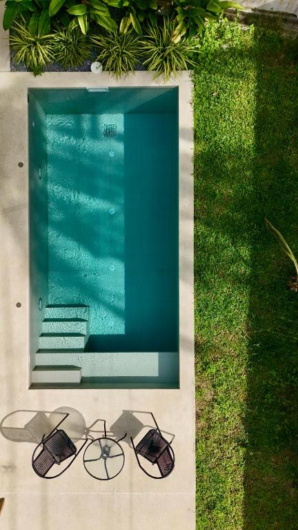 a pair of sunglasses sitting next to a swimming pool at Samma Villas - Agate Villa - 1 BDR & private pool in Ko Phangan