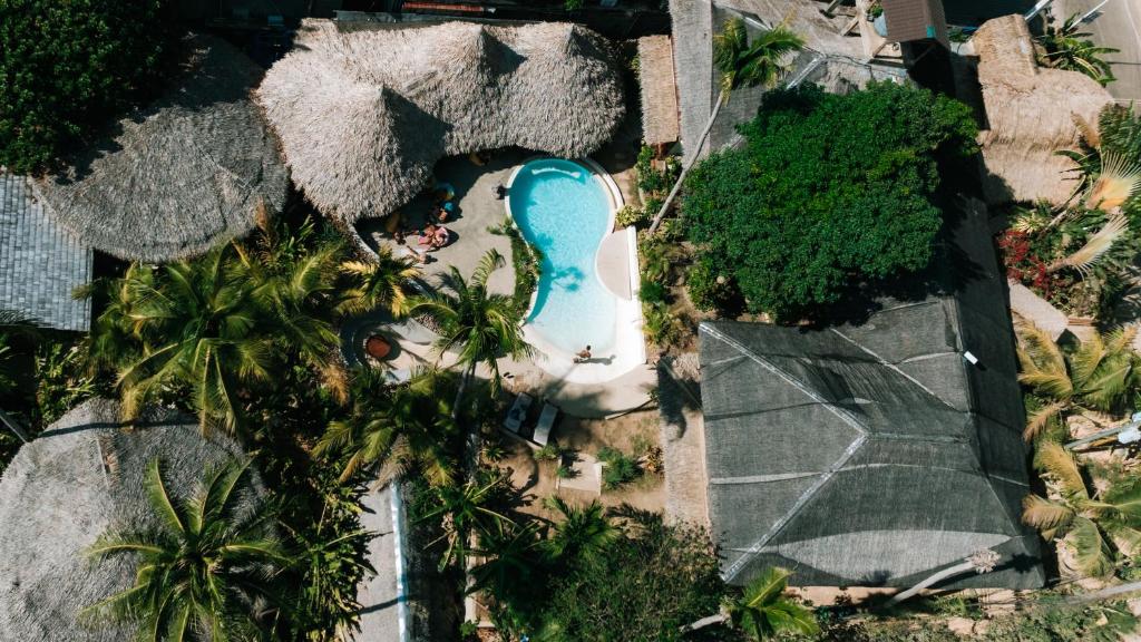 an overhead view of a pool with palm trees at Happiness Boutique Resort El Nido in El Nido