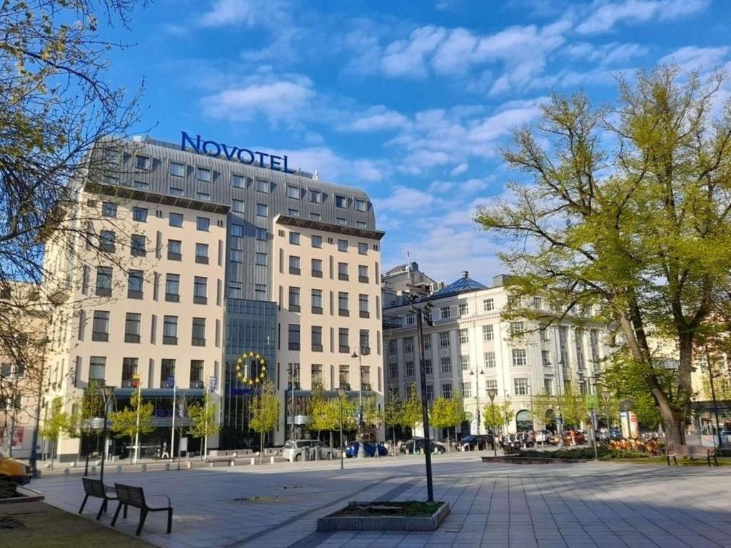 a building with a sign on the top of it at Novotel Vilnius Centre in Vilnius