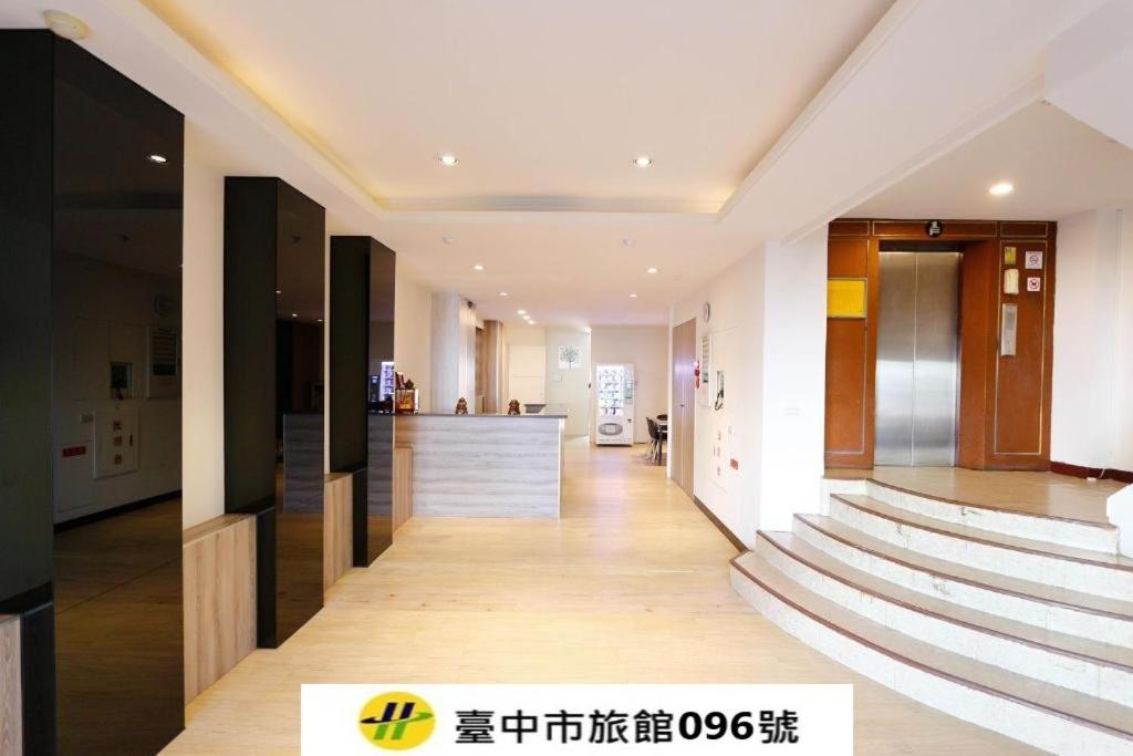 a hallway of a building with stairs and a counter at 東圓旅館 in Taichung