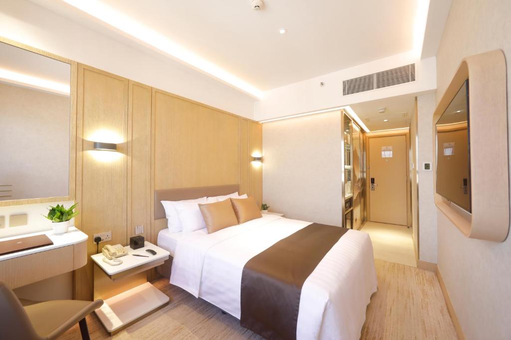 a hotel room with a large bed and a television at B P International in Hong Kong