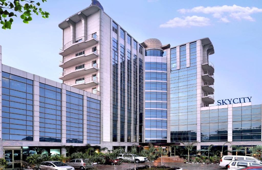 a rendering of a building with cars parked in a parking lot at SkyCity Hotel Gurgaon in Gurgaon