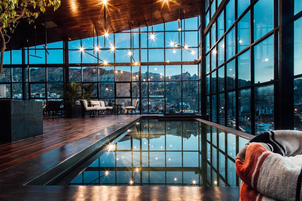 a hotel lobby with a pool and a view of the city at Atix Hotel in La Paz