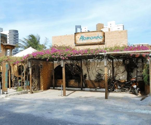 a store with a motorcycle parked in front of it at Pousada Alamanda in Natal