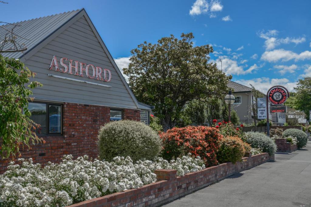 a shop with flowers in front of a building at Ashford Motor Lodge in Christchurch