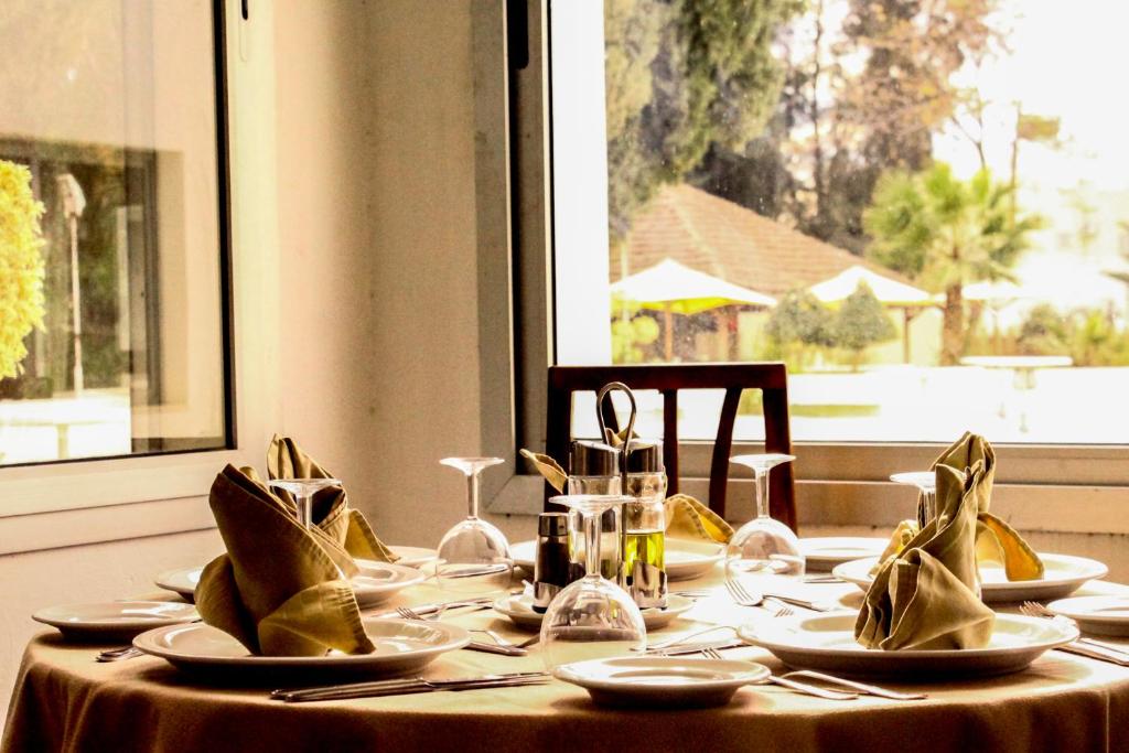 a table with plates and napkins on top of it at Hotel Continental in Kairouan