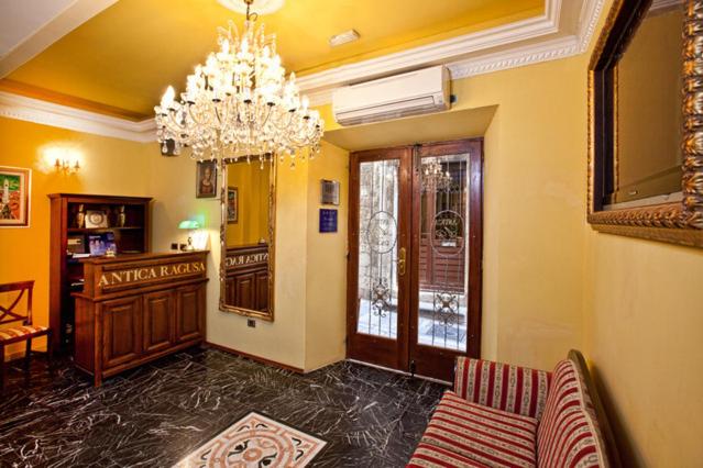 a living room with a chandelier and a couch at Hamlet Bed & Breakfast in Dubrovnik