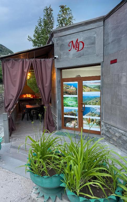 a small house with a patio with a table in it at Guest House MD 2 in Tatʼev
