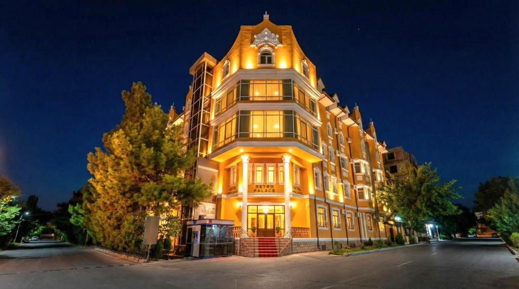 a large building with a clock on top of it at Retro Palace Residence Tashkent in Toshkent-Passajir Bekati
