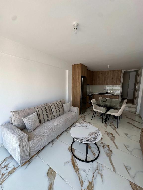 a living room with a couch and a table at WHTheGroundNest in Paralimni