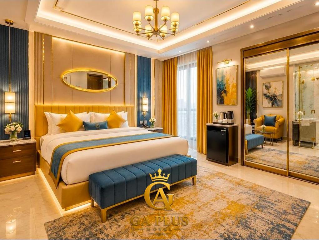 a bedroom with a king sized bed and a living room at GA Cairo Hotel Downtown in Cairo
