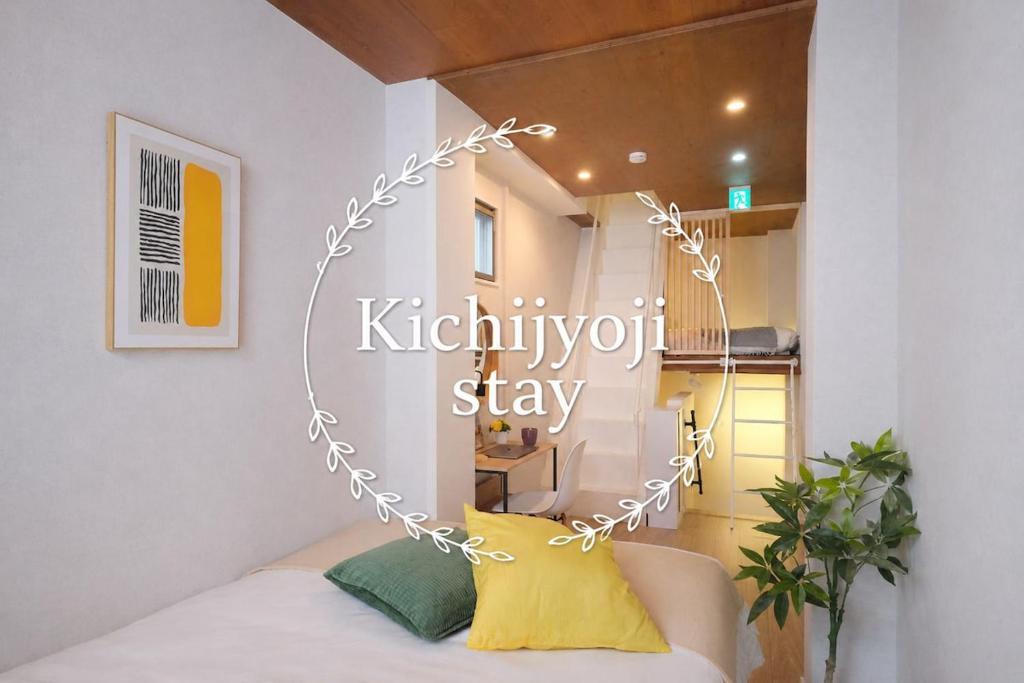 a room with a bed and a sign that reads kittifystay at Dearcourt Kichijoji 1F-3F in Musashino