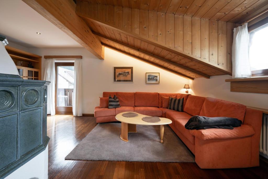 a living room with a couch and a table at Apartments Rezia in Ortisei