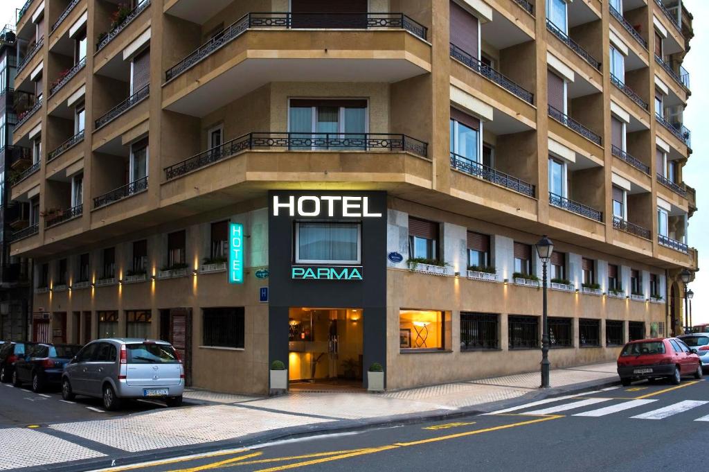 a hotel building on a city street with cars parked outside at Hotel Parma in San Sebastián