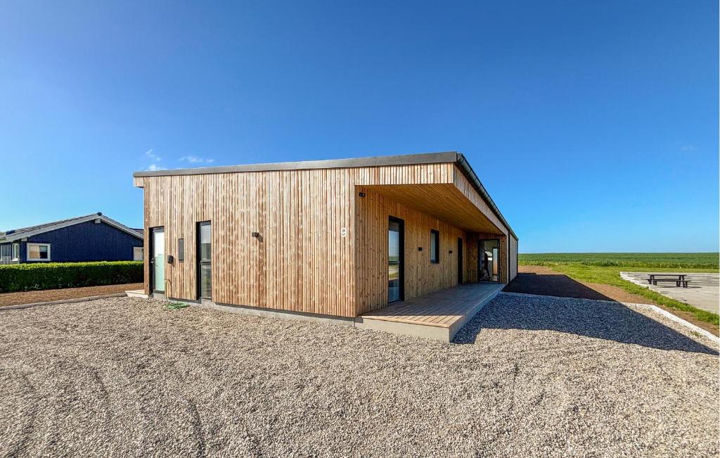 a small wooden building with a porch on a gravel lot at Gorgeous Home In Haderslev With Sauna in Haderslev