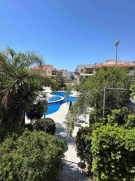 a resort with a swimming pool with trees and bushes at WHTheGardens in Pyla