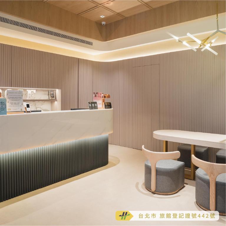 a restaurant with a counter and a table and chairs at Royal Rose Hotel Zhongshan in Taipei