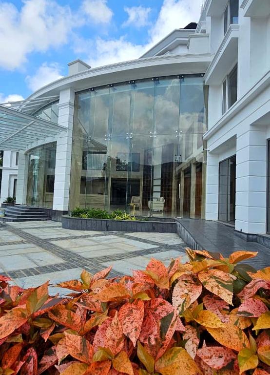 a building with a bunch of leaves in front of it at Surya Grand Hotel in Kalpetta