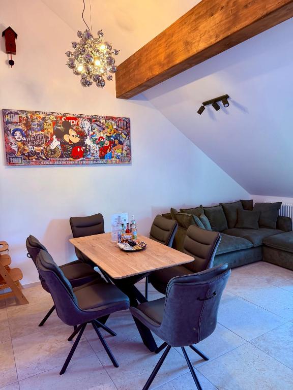 a dining room with a table and a couch at Parkside Apartments Rust in Rust