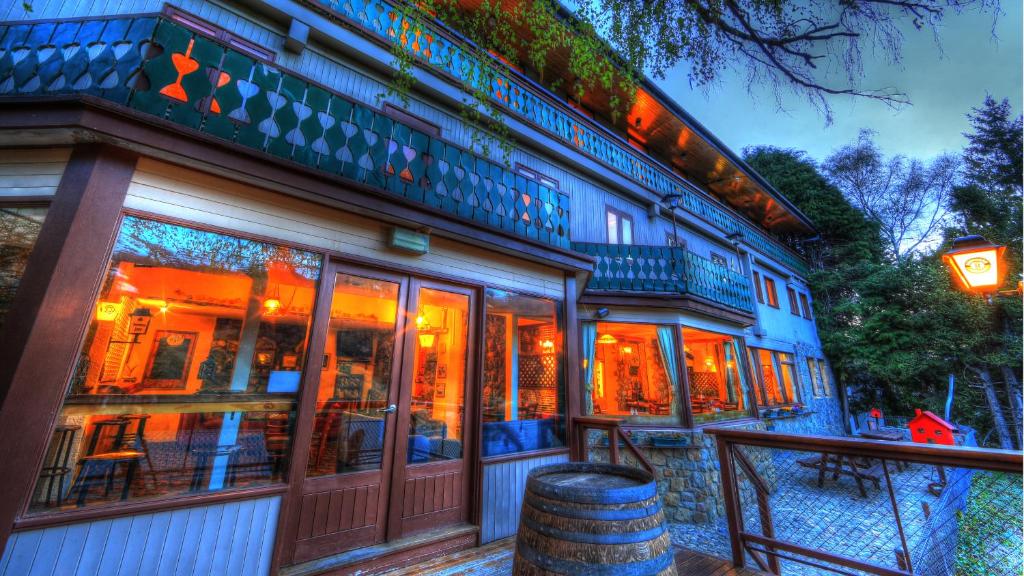 a building with a barrel in front of it at Candlelight Lodge in Thredbo