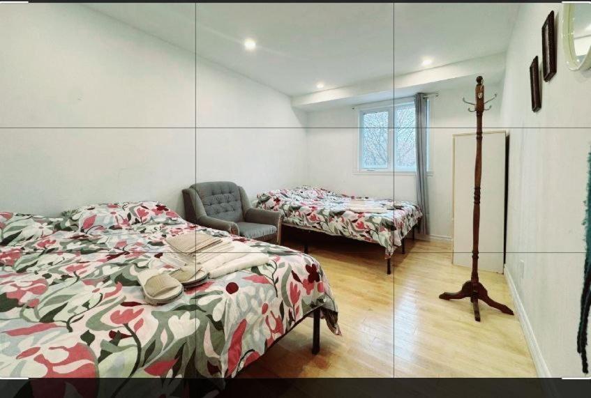 a bedroom with two beds and a mirror at Family-Friendly Private Room With 2 Queen Beds in Brossard