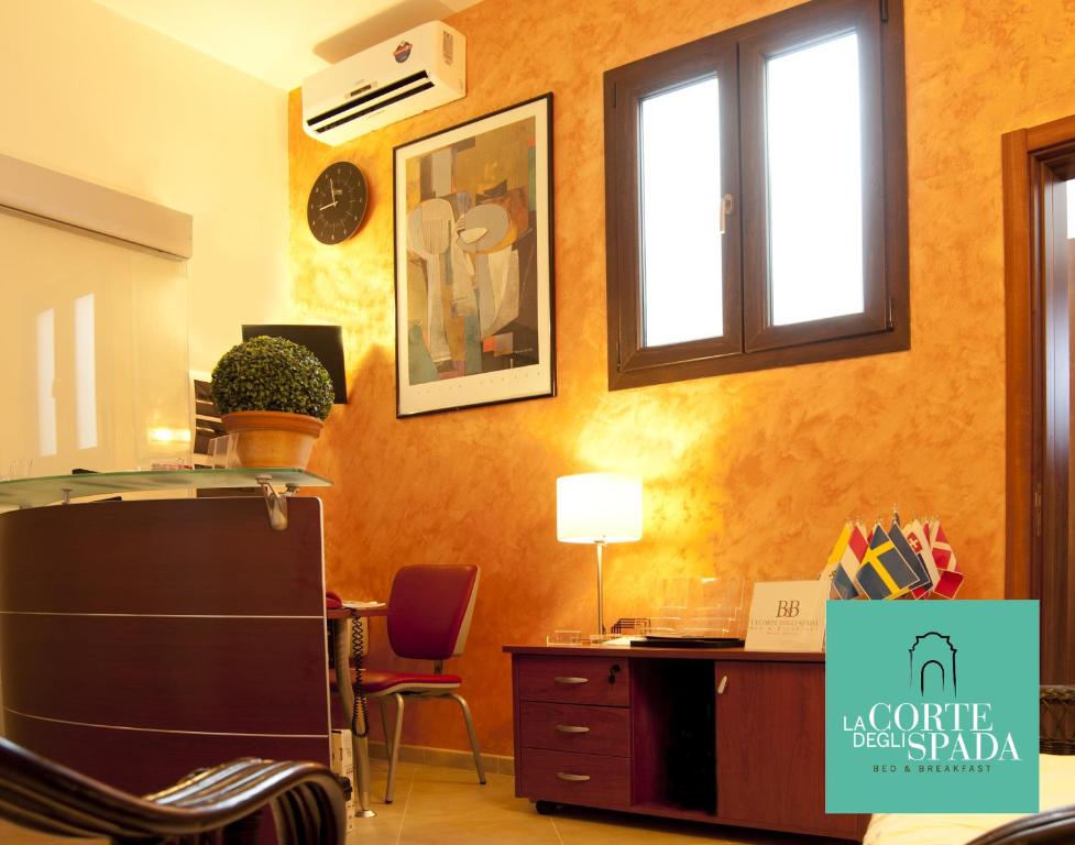 an office with a desk and two chairs and a window at B&B La Corte degli Spada - Borgo Antico del Salento in Mesagne