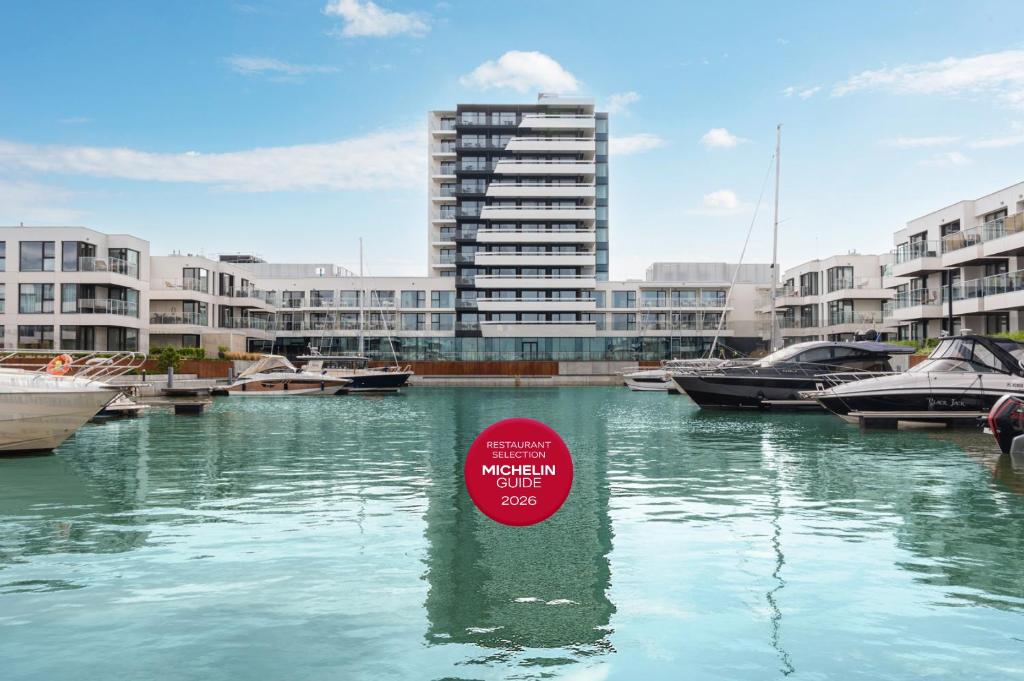 a sign in the water in a marina with boats at GRANO HOTEL Solmarina & Apartments - SPA&Wellness in Wiślinka