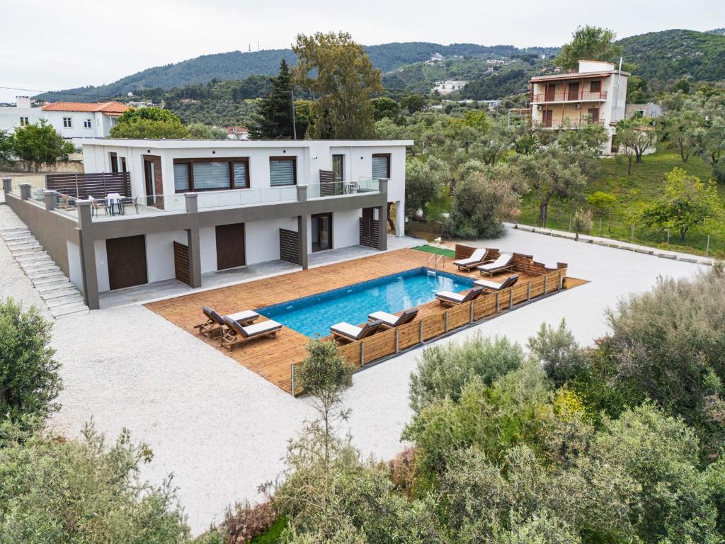 an aerial view of a house with a swimming pool at Pnoes Suites Apartments in Skiathos