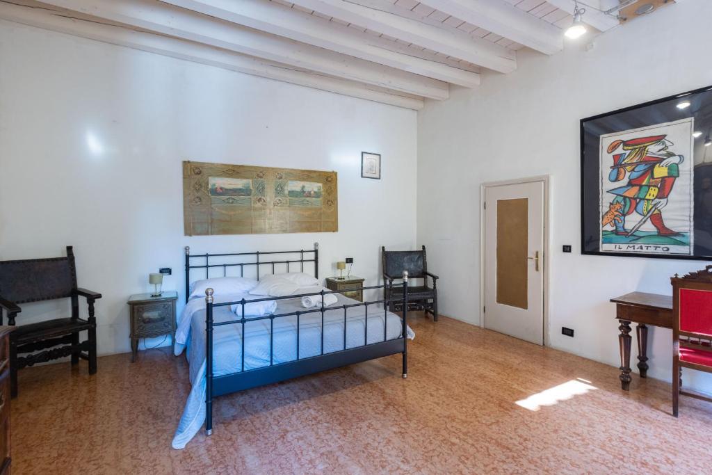 a bedroom with a bed and a painting on the wall at Nel Cuore di Bologna L ,Bologna by Shortholidays in Bologna