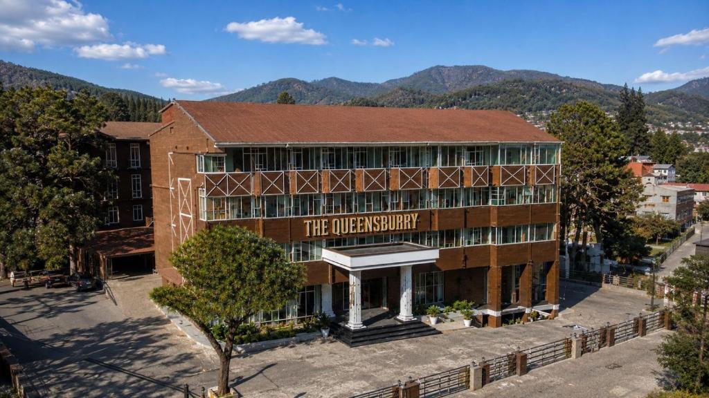 an old building with a sign that reads the university at The Queensburry City Hotel in Nuwara Eliya