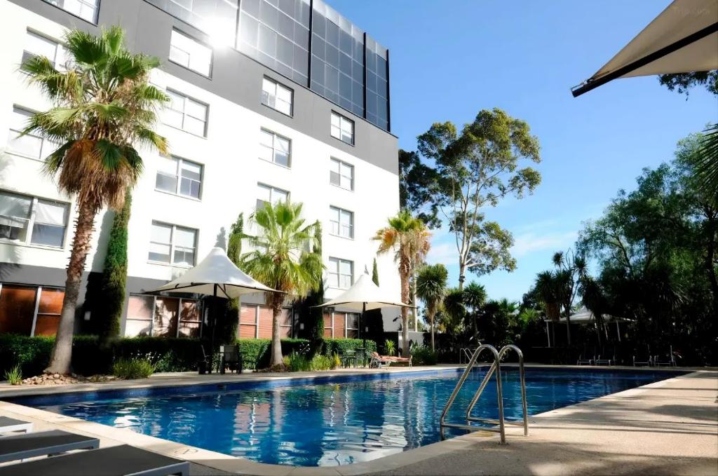 a swimming pool in front of a building at Together Co-Living Melbourne in Melbourne